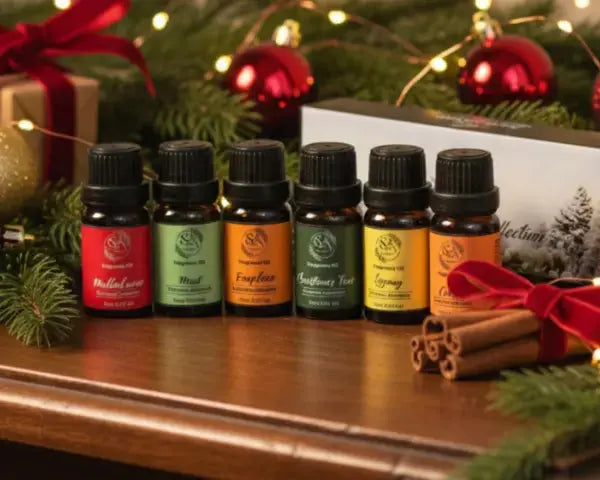 Set of essential oil bottles with Christmas decorations on a wooden surface