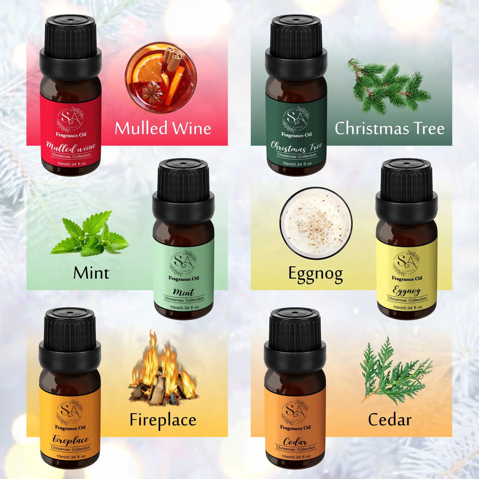 Collection of Christmas diffuser oil bottles with labels for Mulled Wine, Christmas Tree, Mint, Eggnog, Fireplace, and Cedar on a decorative background.