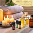 Candlelit scene with essential oil bottles and towels, promoting a touch of luxury.
