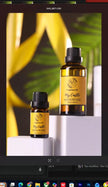 Two bottles of 'My Castle' fragranced oil on a white surface with green leaves in the background.