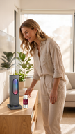 Woman noticing the scent from the Essence waterless diffuser in a bright modern living room